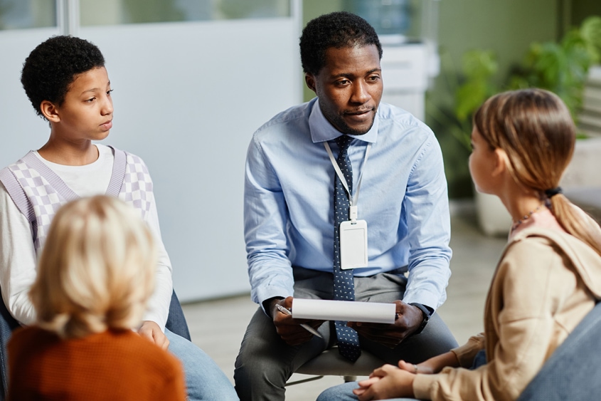 School psychologist meeting with a group of students