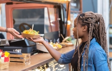 Women getting food from a food truck