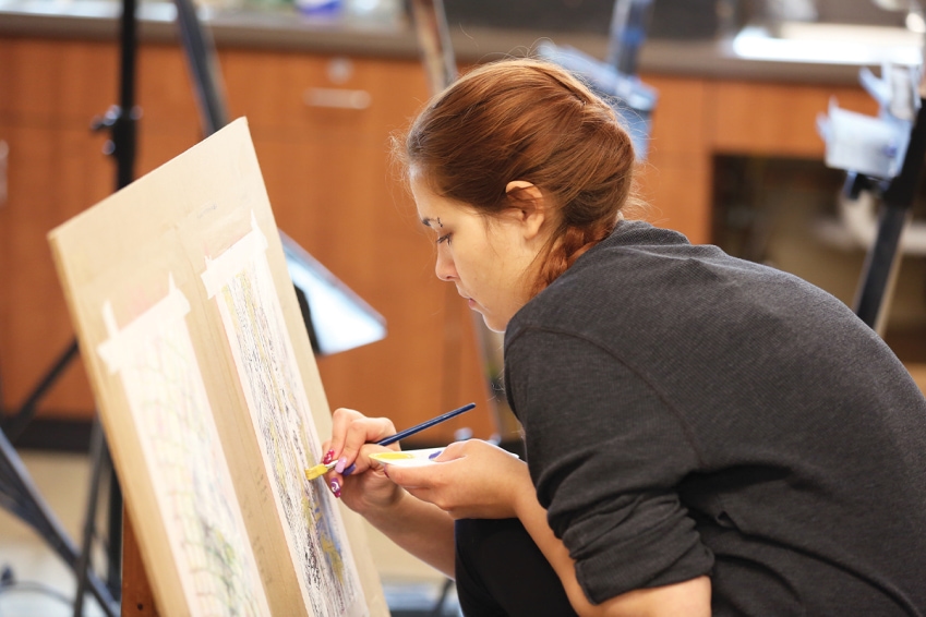 Art student painting in studio