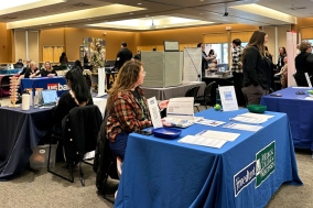 Employer tables set up at a career fair at Alverno College