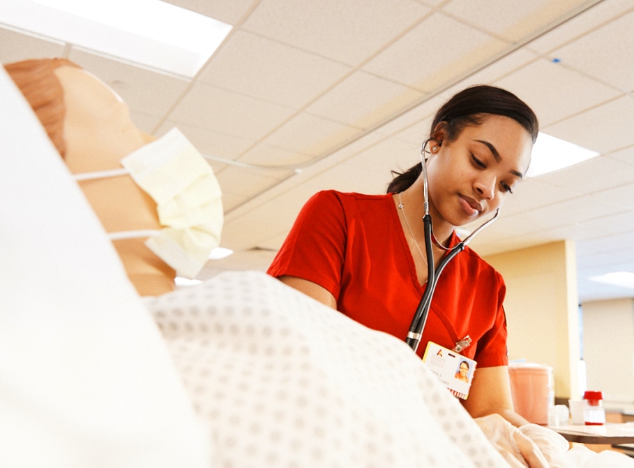 Nursing student works in a sim lab