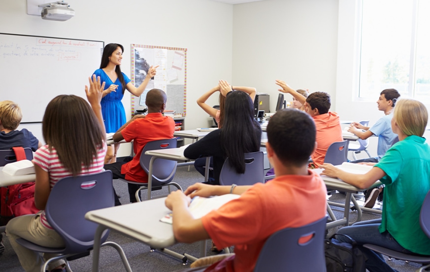 Para to teacher student teaching in front of classroom