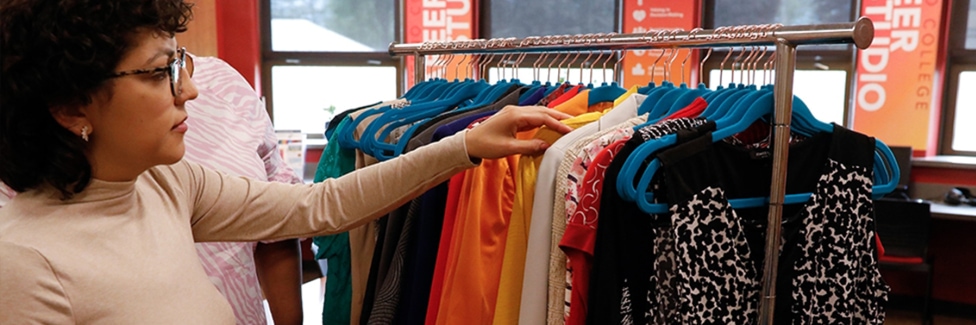 Young woman browses professional clothing in the Career Studio Boutique