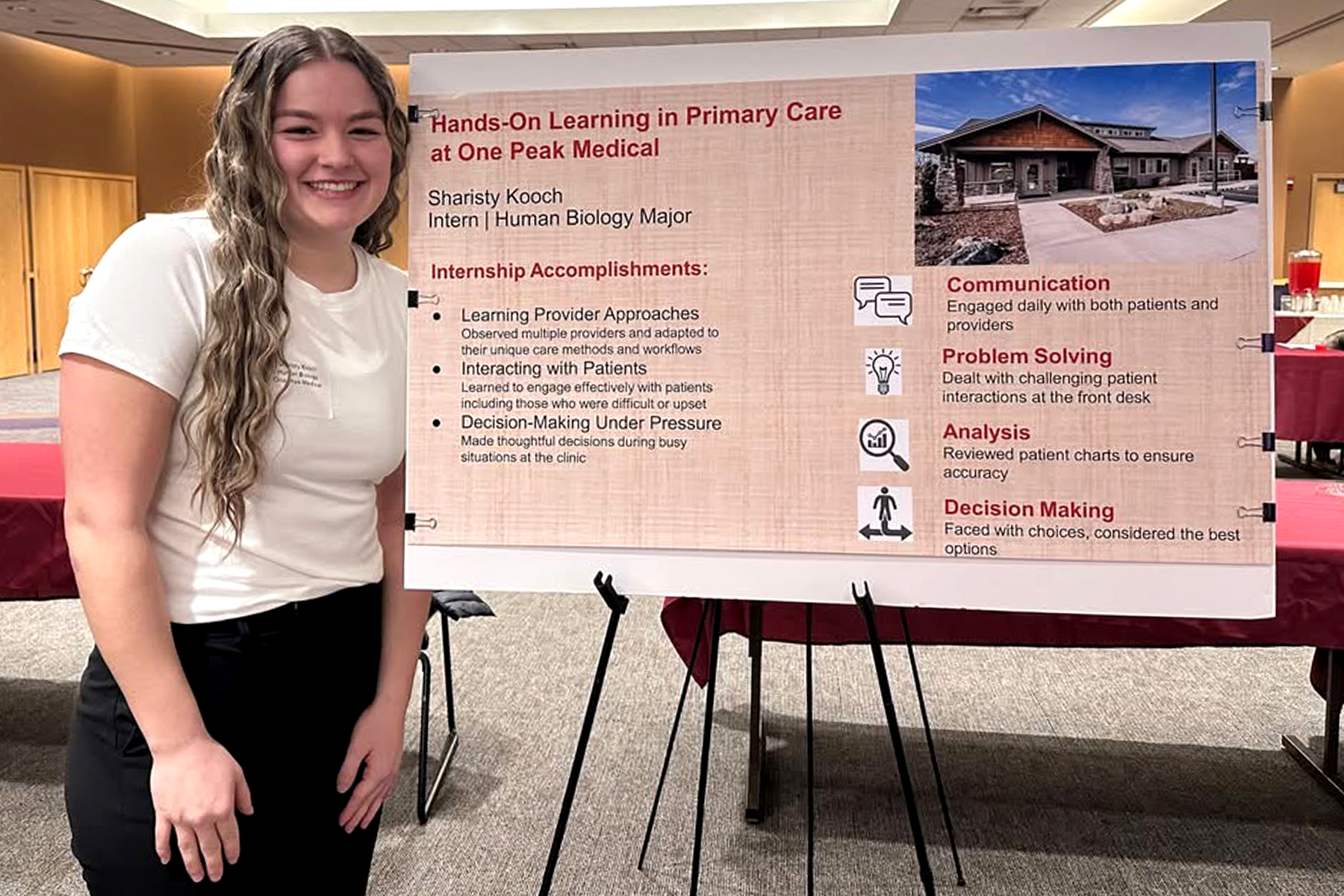 An Alverno student shows her poster about her education internship