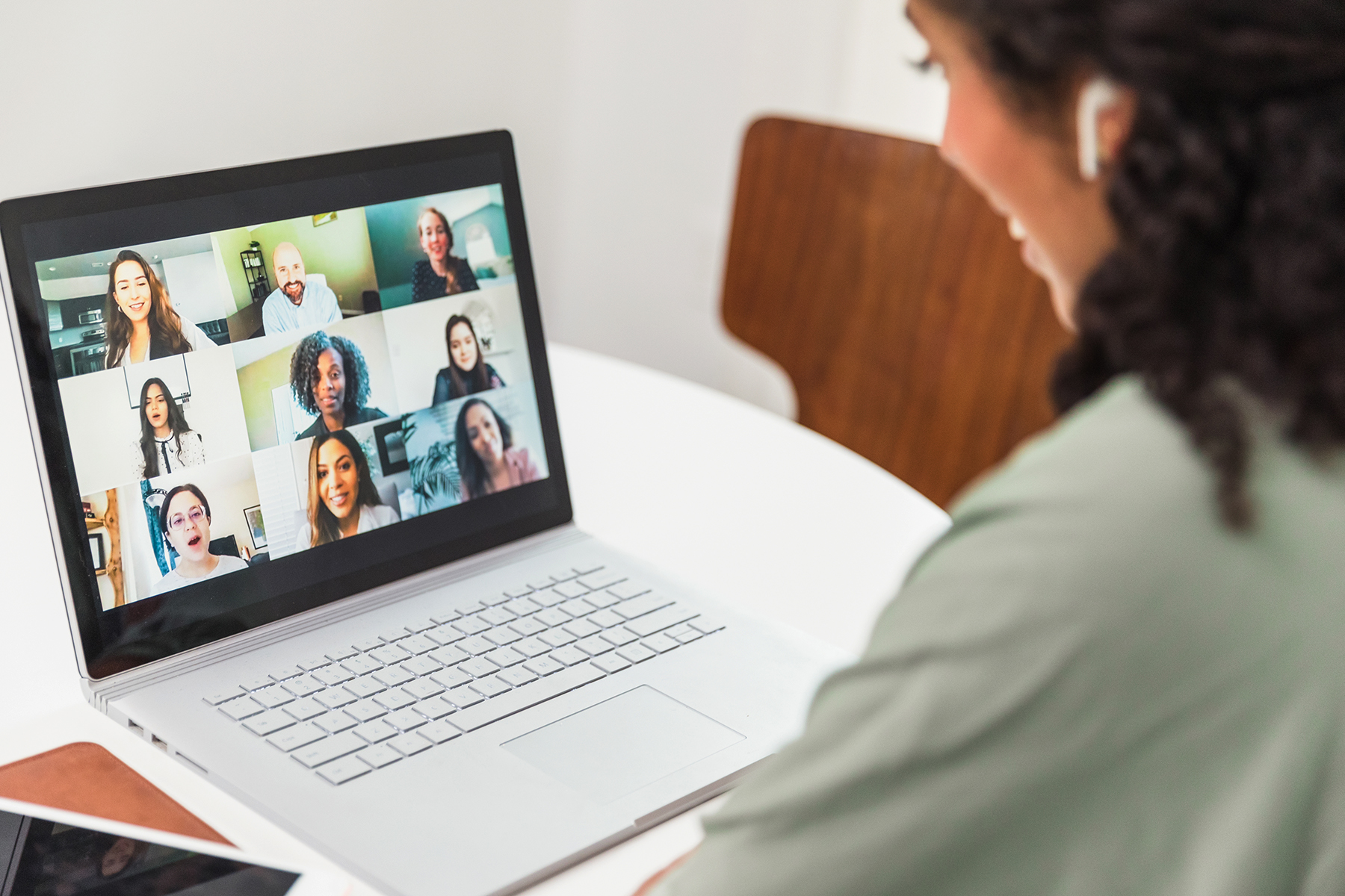 Student has a virtual interview with a team on her laptop